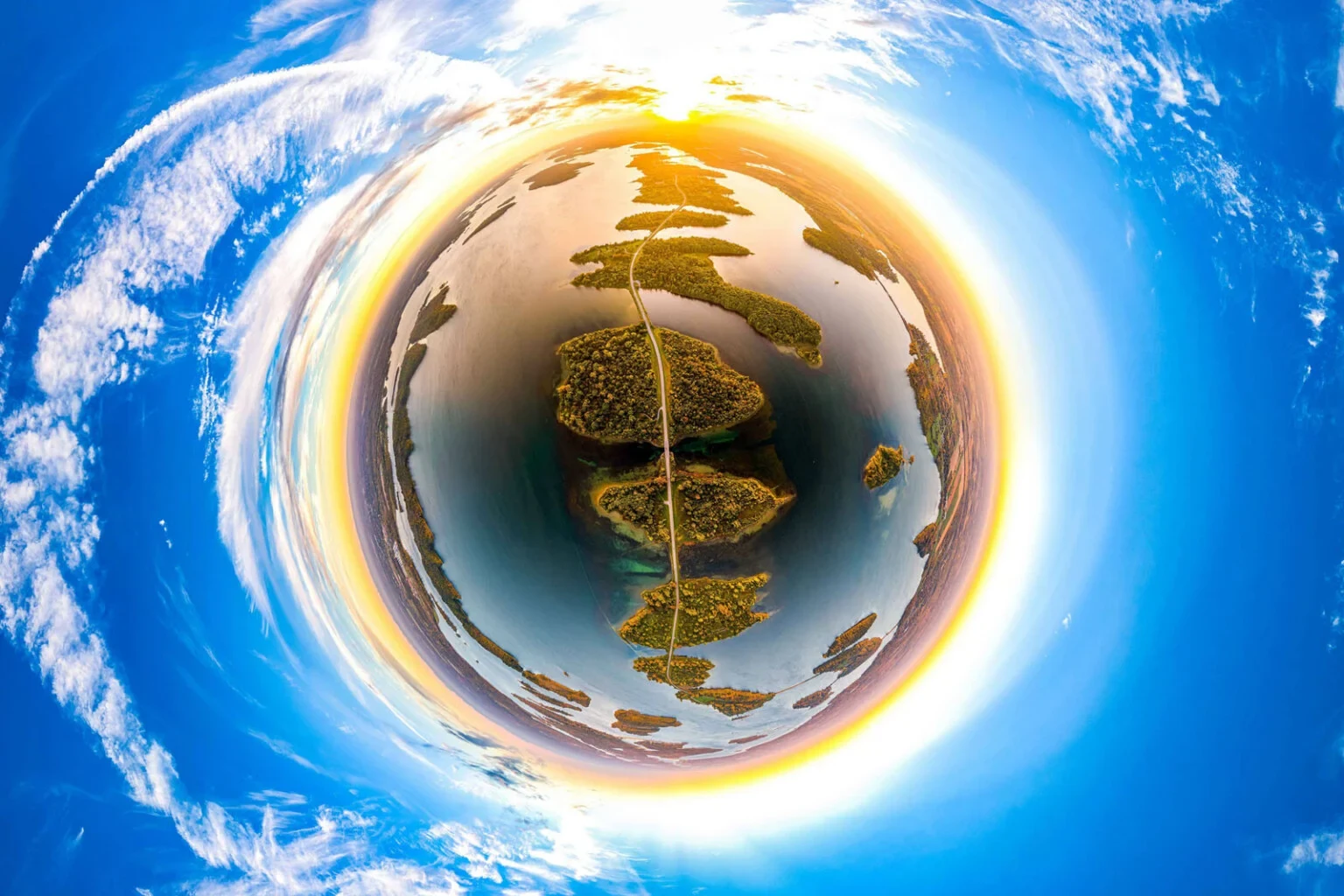 A stereographic tiny-planet aerial view shows a road linking islands in Lake St. Lawrence.