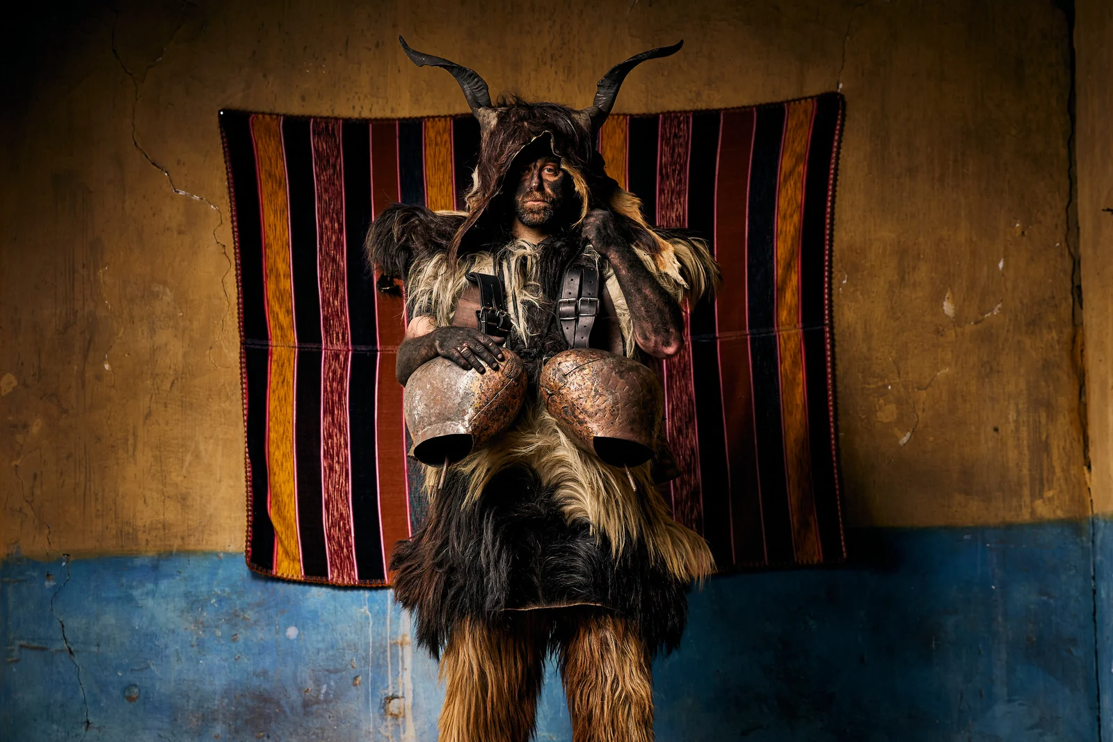 Arapis participant wearing horns, animal skins and bells