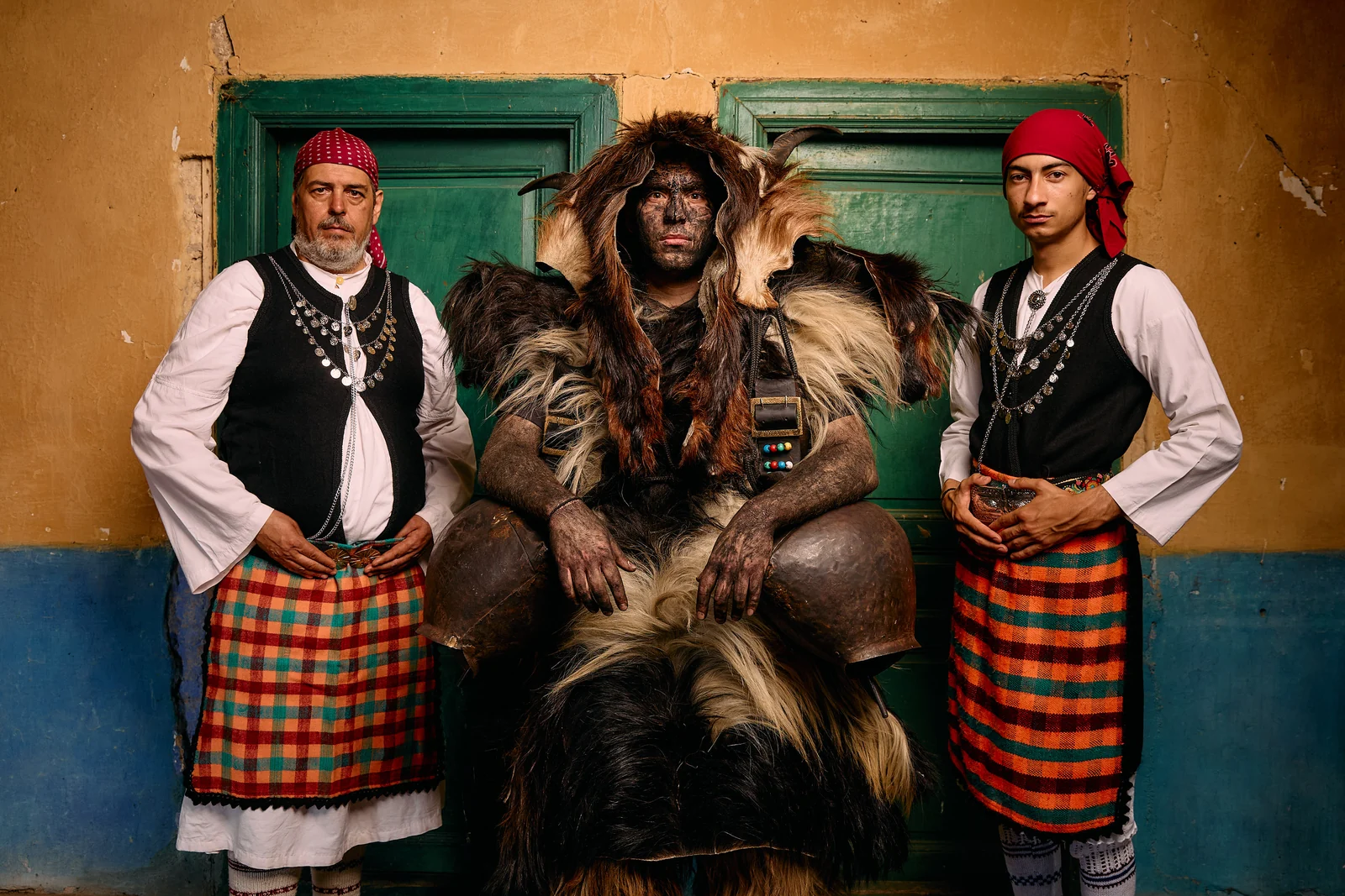 Arapis participant between two men in traditional Petrousa dress