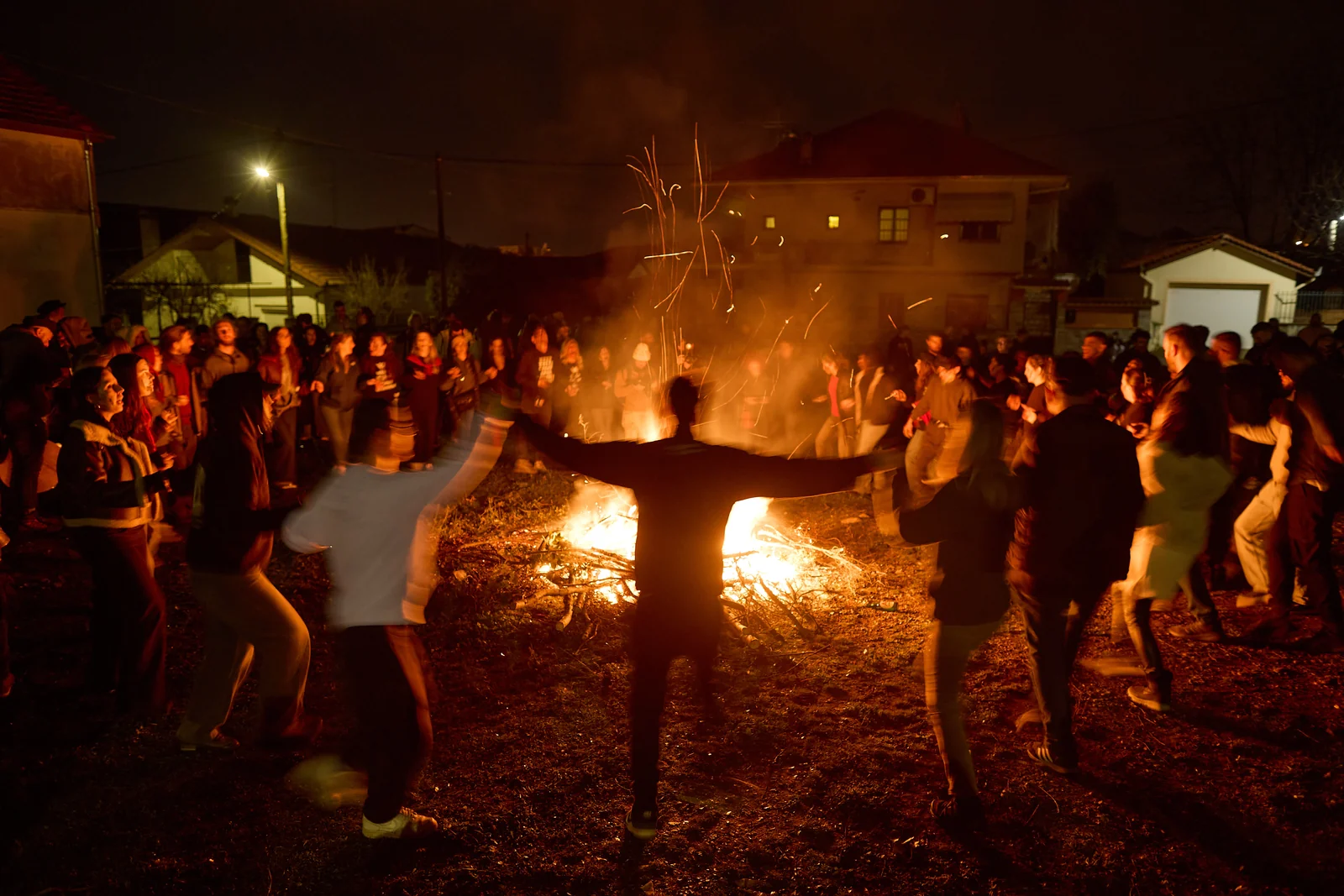 Residents dance around the fire during Babinten