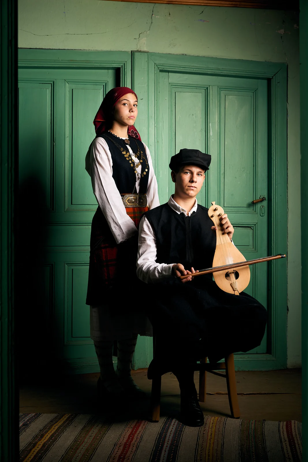 Young woman in traditional dress and a lyra player in Petrousa