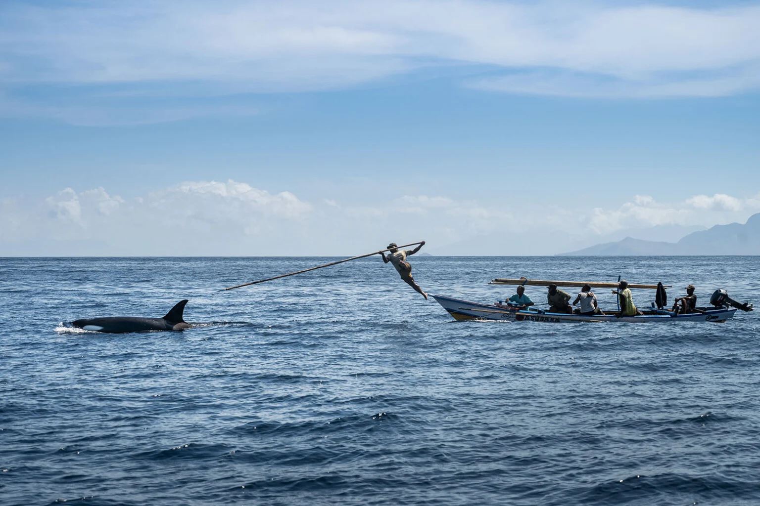 A fisherman leaps from a boat to strike an orca with a hand-thrown harpoon in Lamalera, Indonesia.