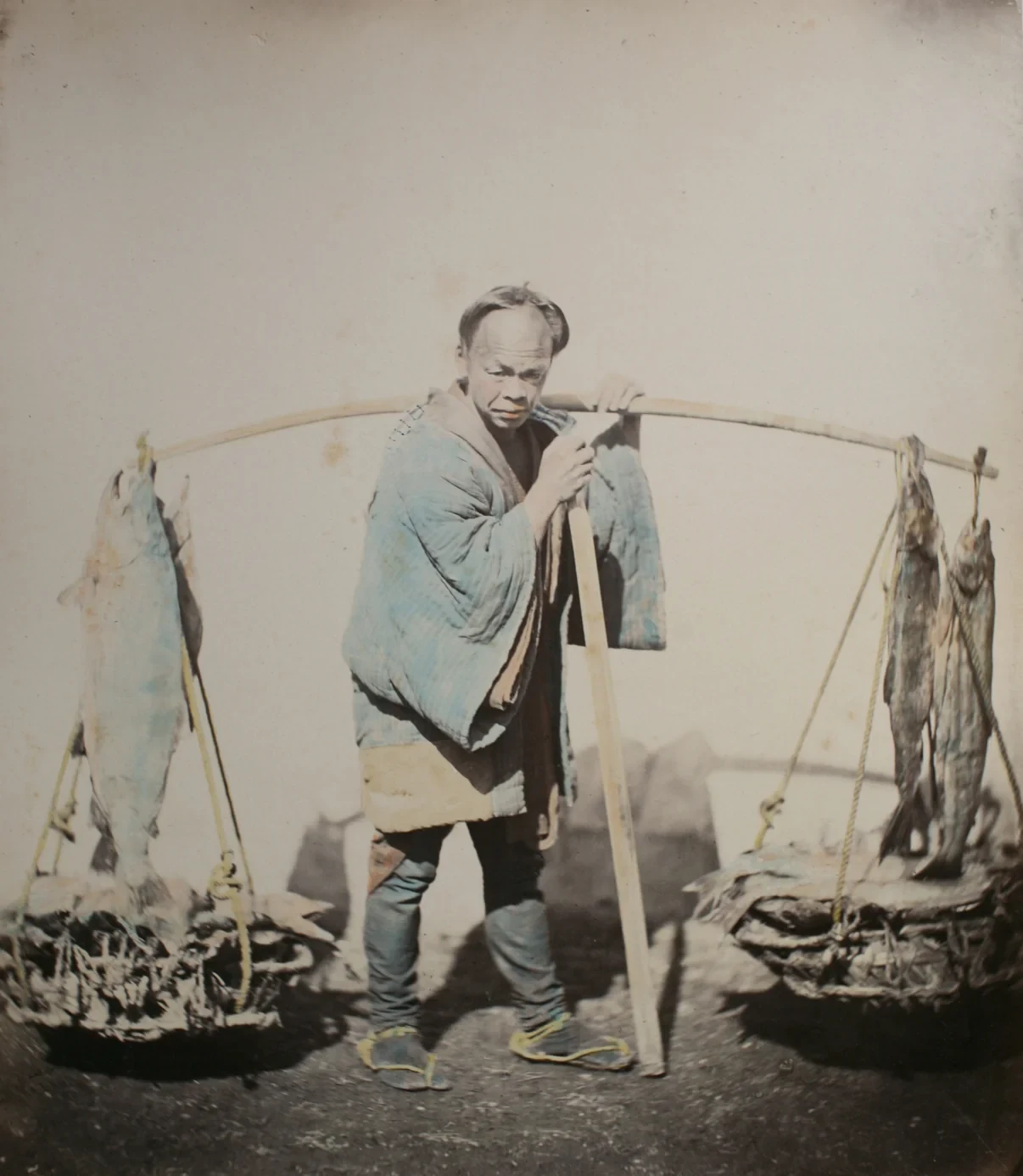Historical hand-coloured photograph of a fish seller in The Yokohama Project