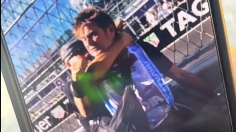 Police Officer Restrains Formula 1 Photographer at Spanish GP