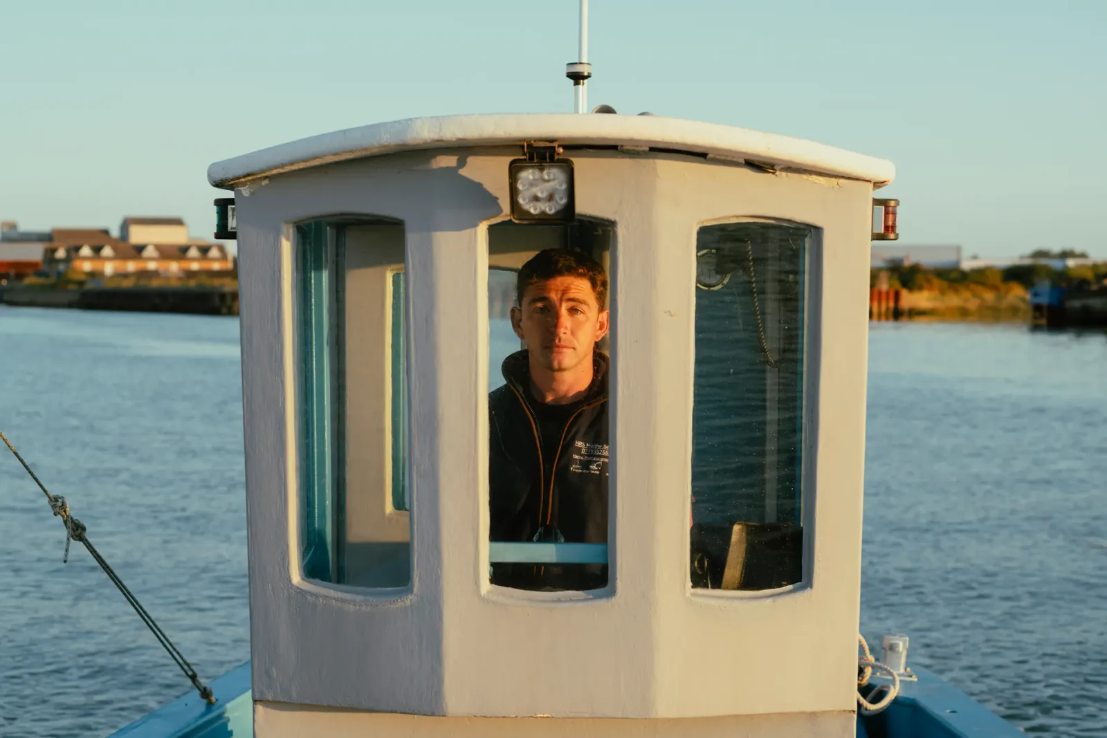 Man in a boat cabin photographed with Leica Summicron-M 66 f/2