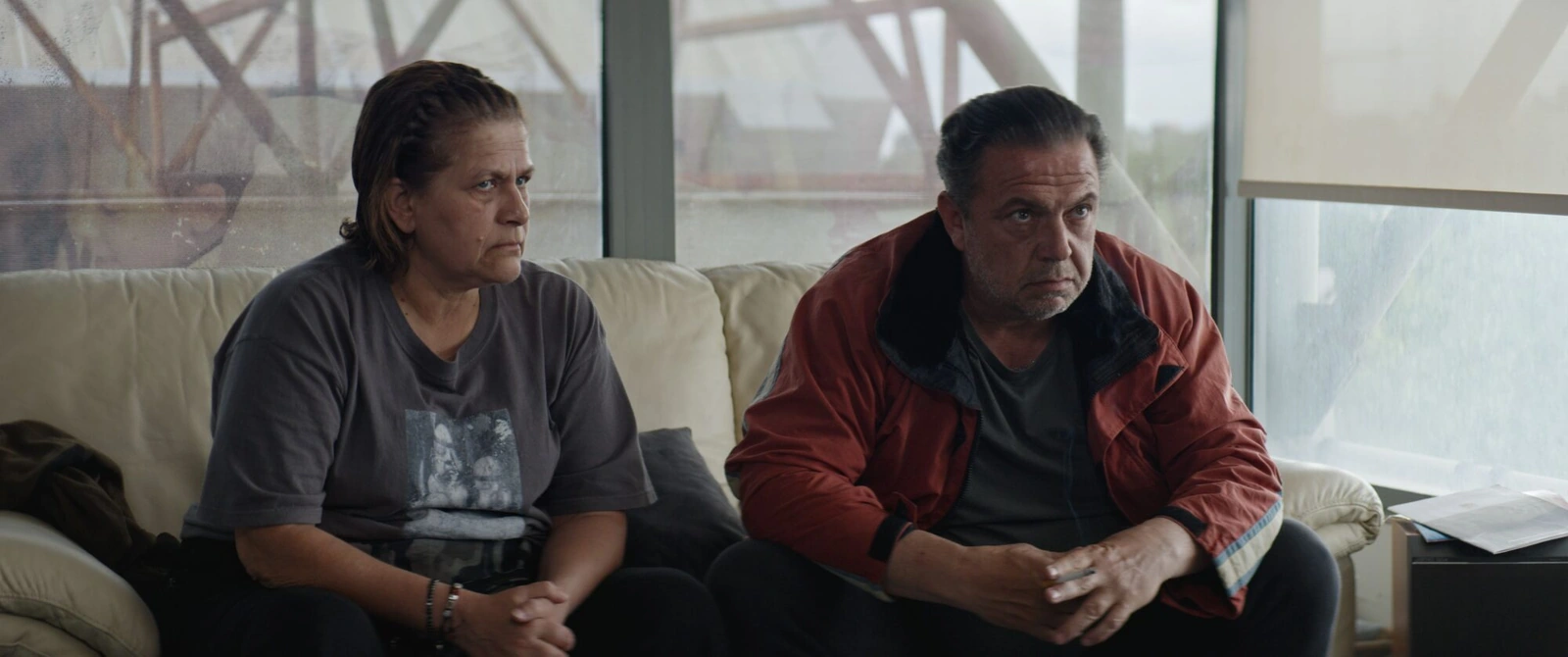 A woman and a man seated side by side on a sofa