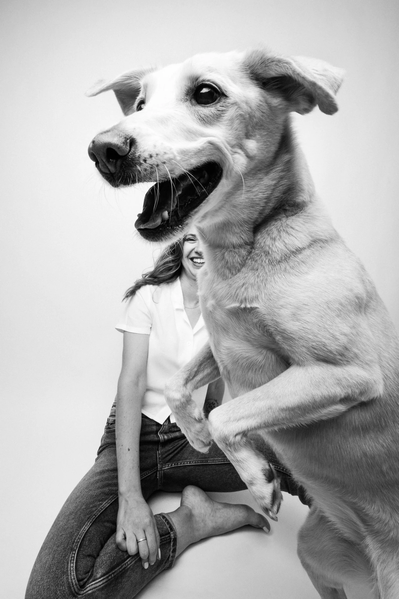 A black-and-white portrait of a dog and person in Eco Lorka’s Nika & Sherry