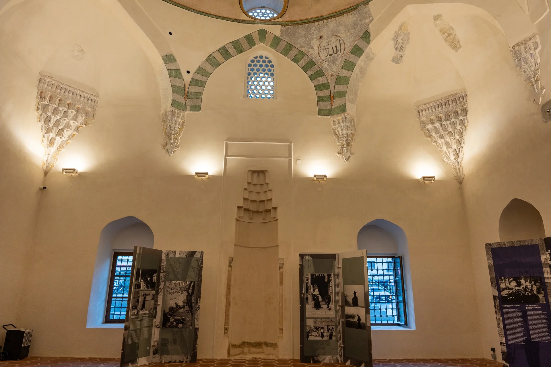 Rows of green and pale stone arches inside the restored monument