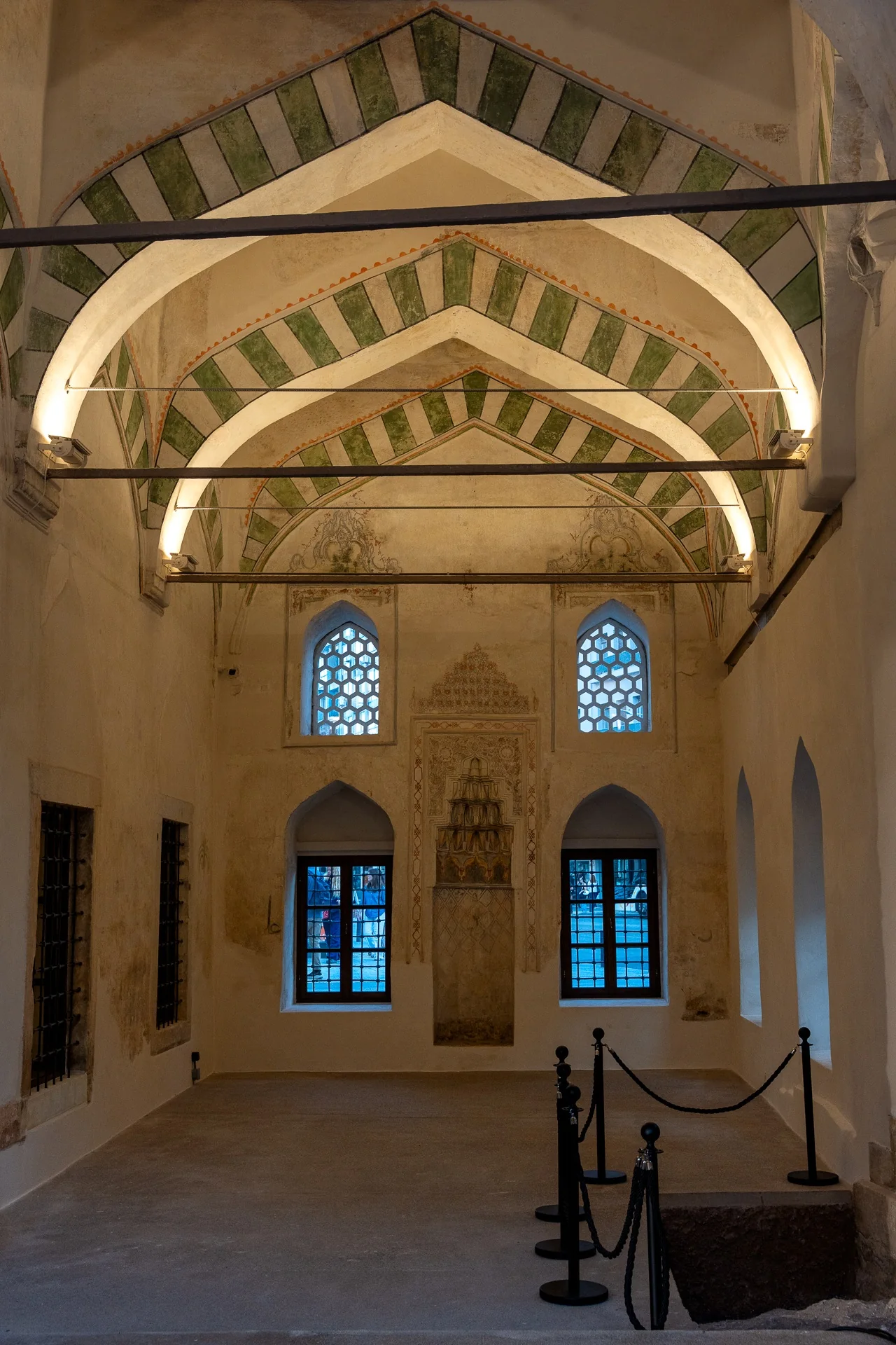 Interior of Hamza Bey Mosque with arches and a decorated niche