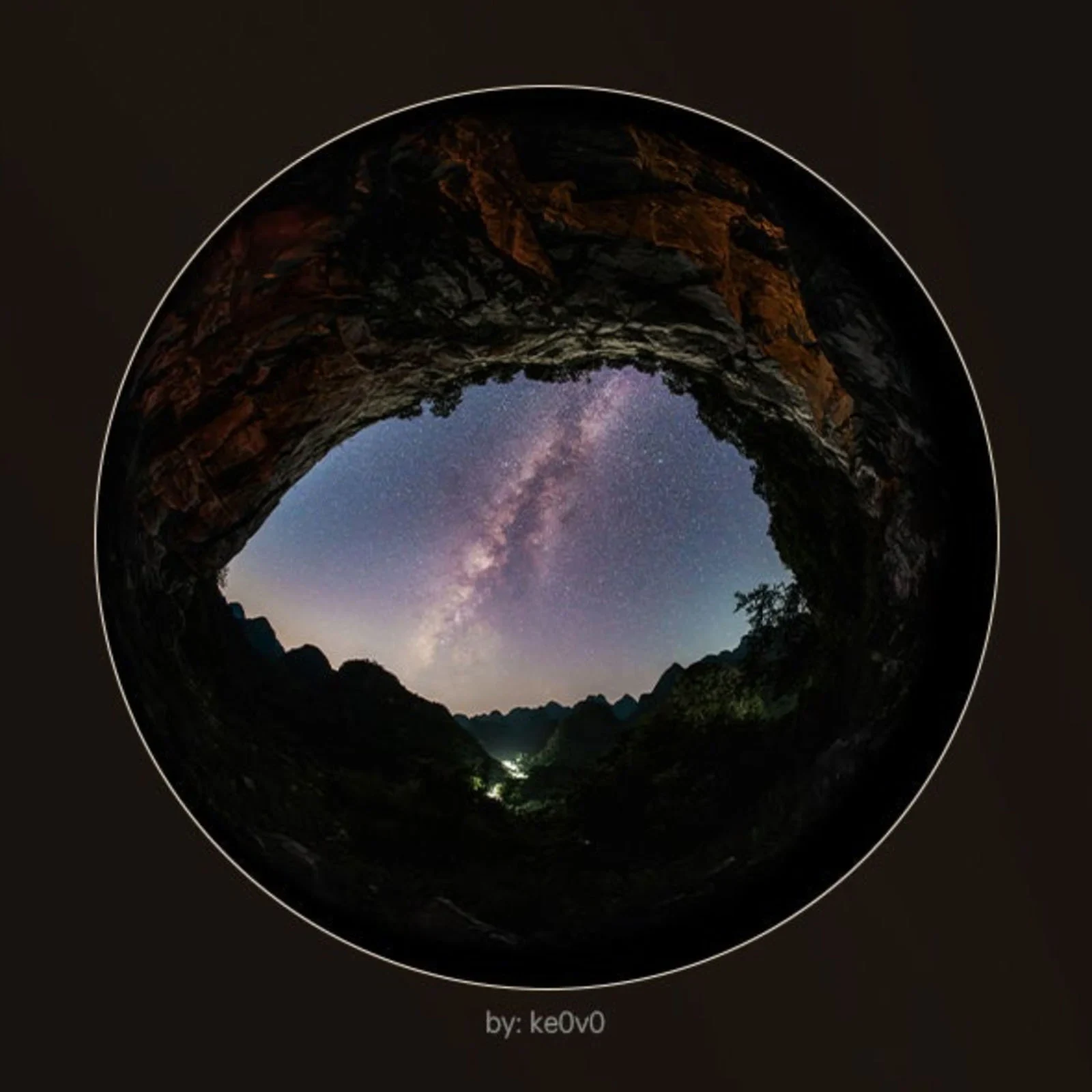 Milky Way above rocky hills in a circular fisheye photograph