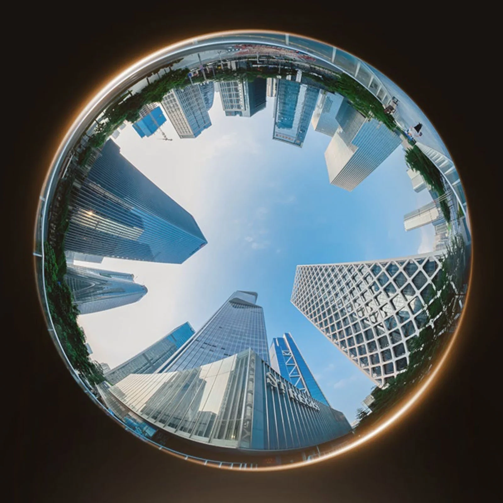 Circular fisheye view looking upwards between skyscrapers