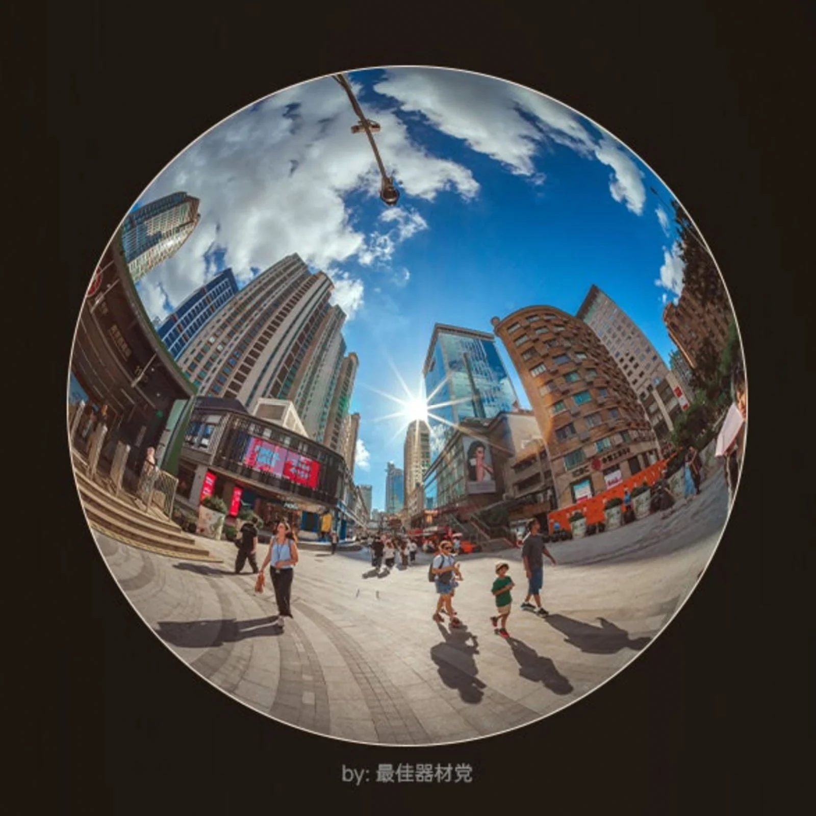 Round fisheye image of an urban square beneath a blue sky