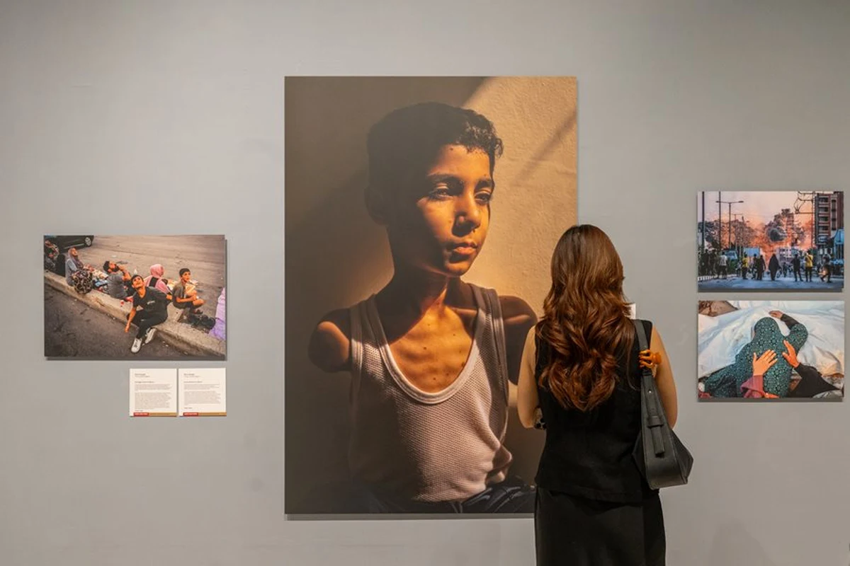 Visitor studying a photograph at a World Press Photo exhibition