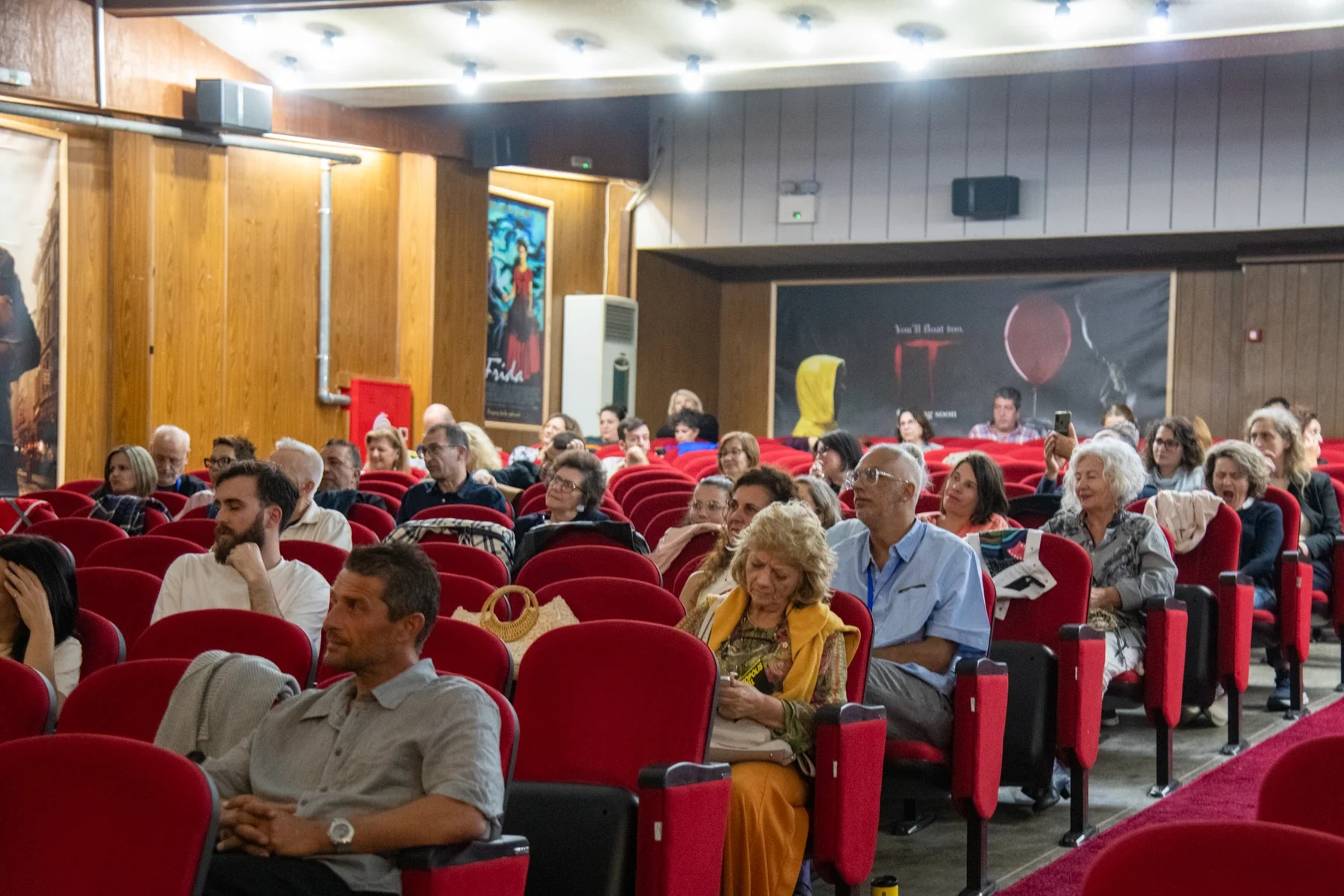 Audience sitting in red cinema seats during a Photopolis screening event