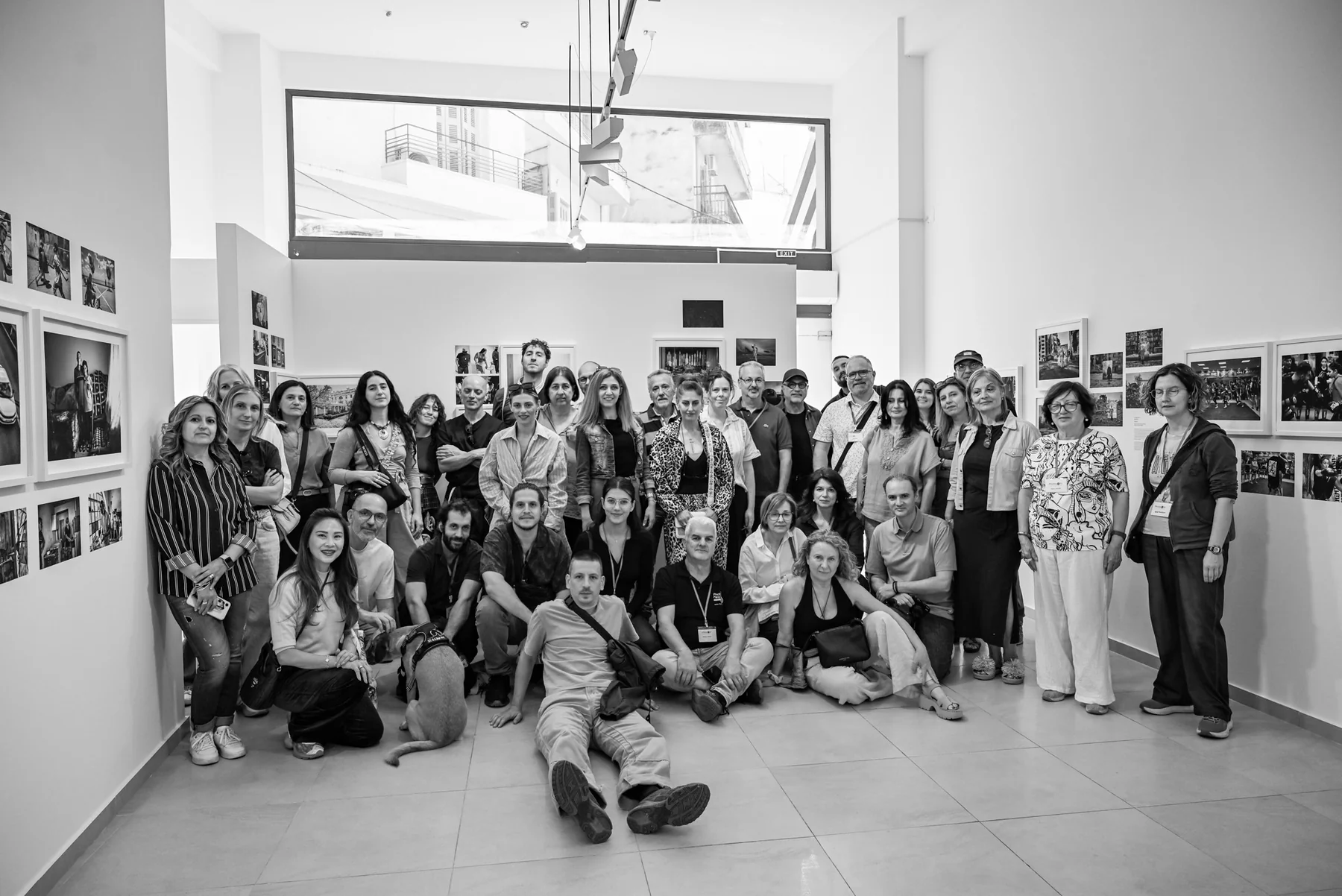 Group portrait of photographers and visitors inside a Photopolis exhibition gallery