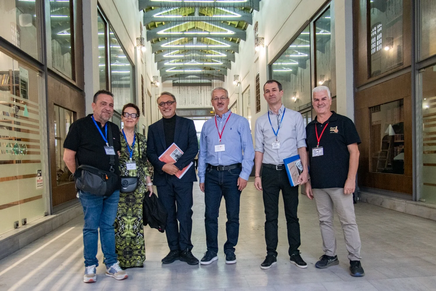 Six Photopolis guests posing together in an indoor passageway