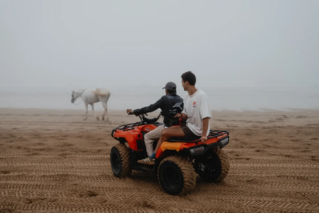 Lifestyle scene with an ATV and horse on a beach